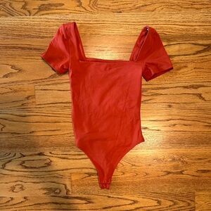 Aritzia orange bodysuit